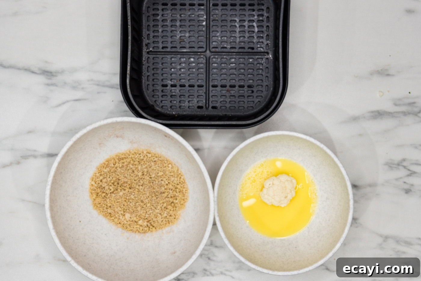 Crispy Air Fried Cauliflower 6 cauliflower florets in a bowl of egg and water