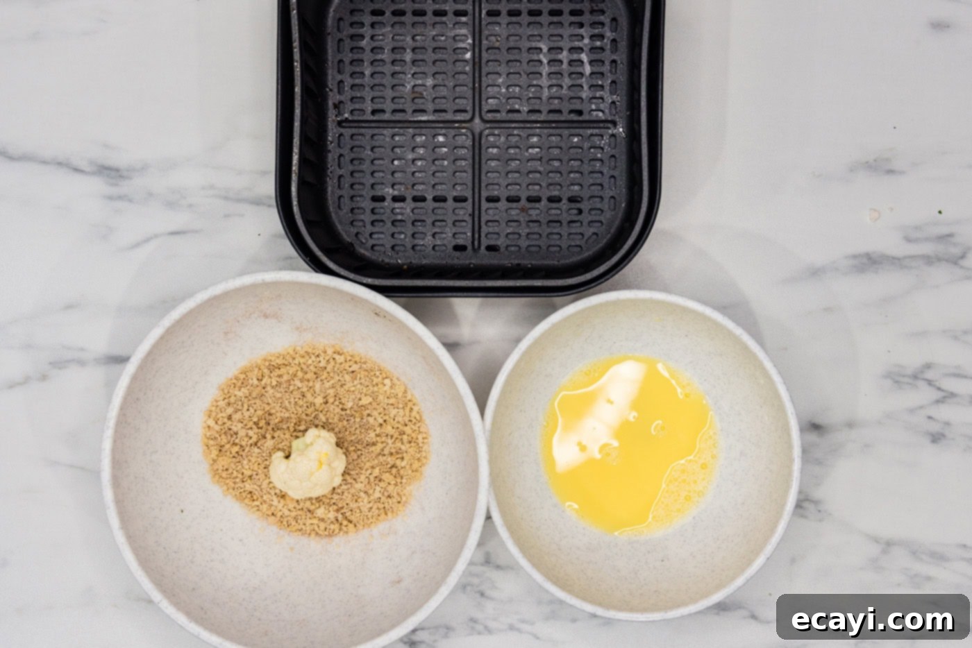 Crispy Air Fried Cauliflower 7 egg dredged cauliflower floret in a bowl of panko breadcrumbs