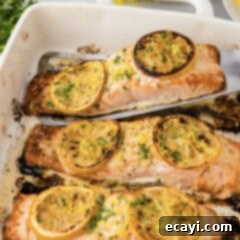 Zesty Lemon Salmon Bake 10 Baked Lemon Salmon fillet being lifted out of the pan, highlighting its succulent texture and golden-brown crust.