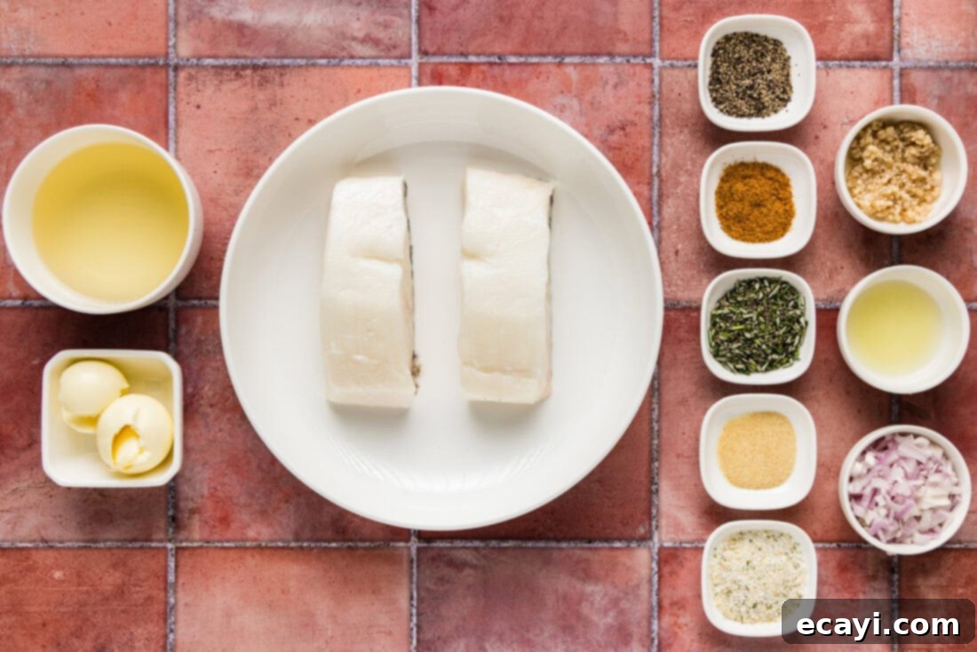 Coastal Elegance: Steamed Chilean Sea Bass 4 A flat lay of fresh ingredients laid out for Steamed Chilean Sea Bass, including fish, butter, shallots, lemon, and seasonings.