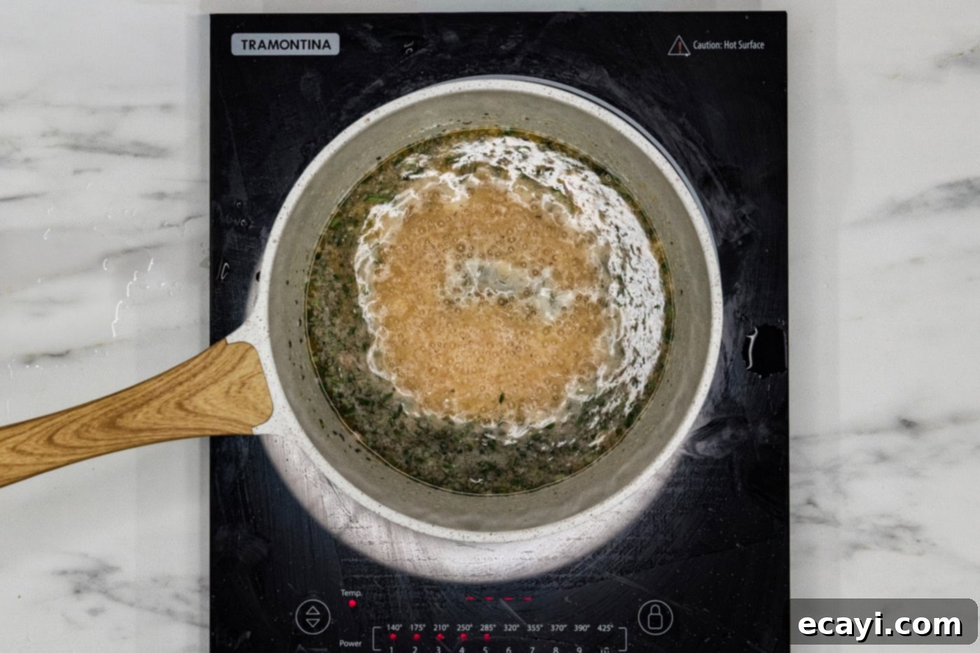 Coastal Elegance: Steamed Chilean Sea Bass 6 The delicious white wine sauce for Chilean sea bass simmering gently in a saucepan.