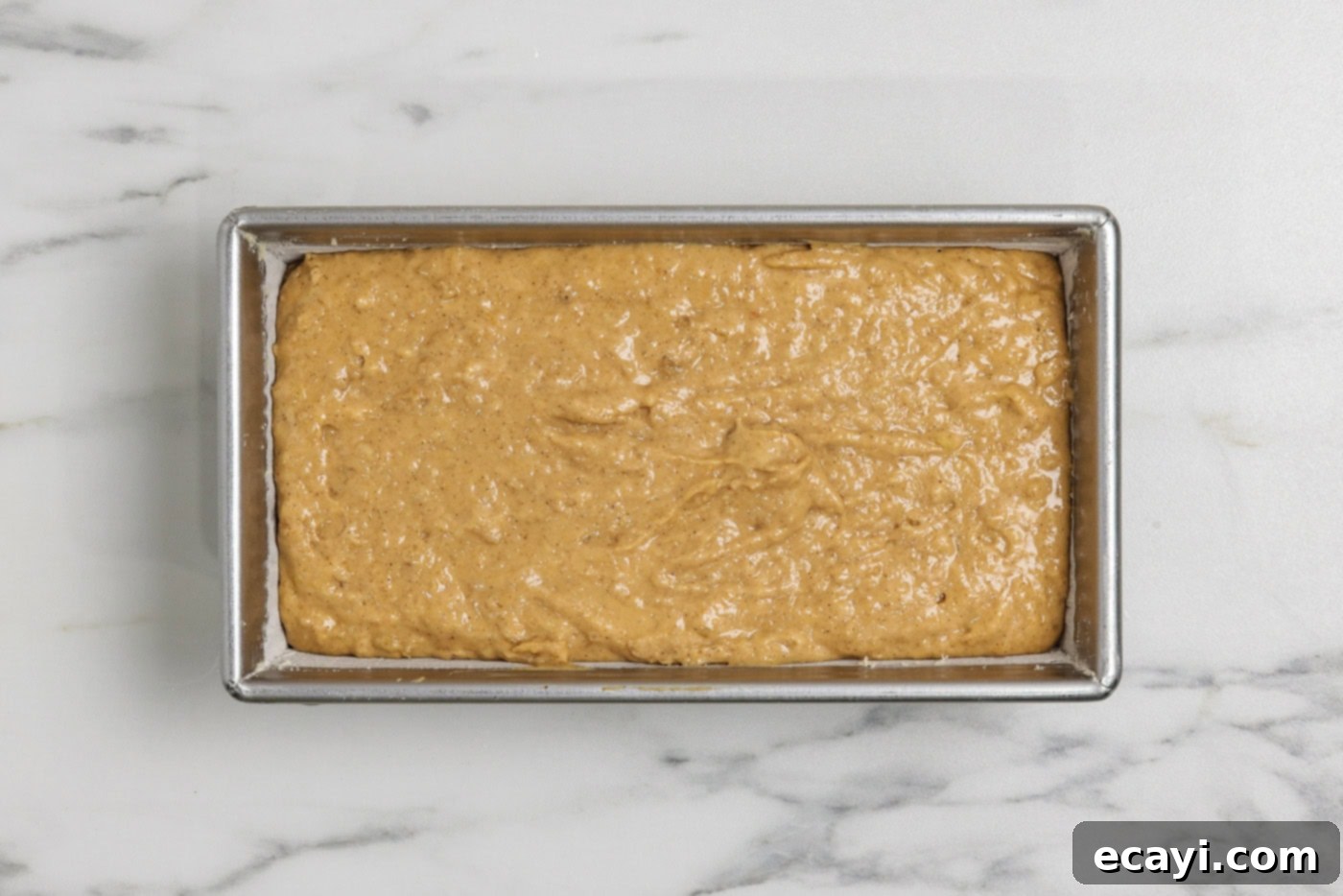 Spiced Pumpkin Banana Loaf 13 pumpkin banana bread batter in a floured loaf pan