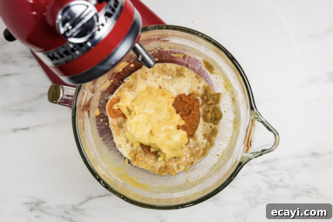 Spiced Pumpkin Banana Loaf 8 spices, pumpkin, and banana added to mixture in stand mixer bowl