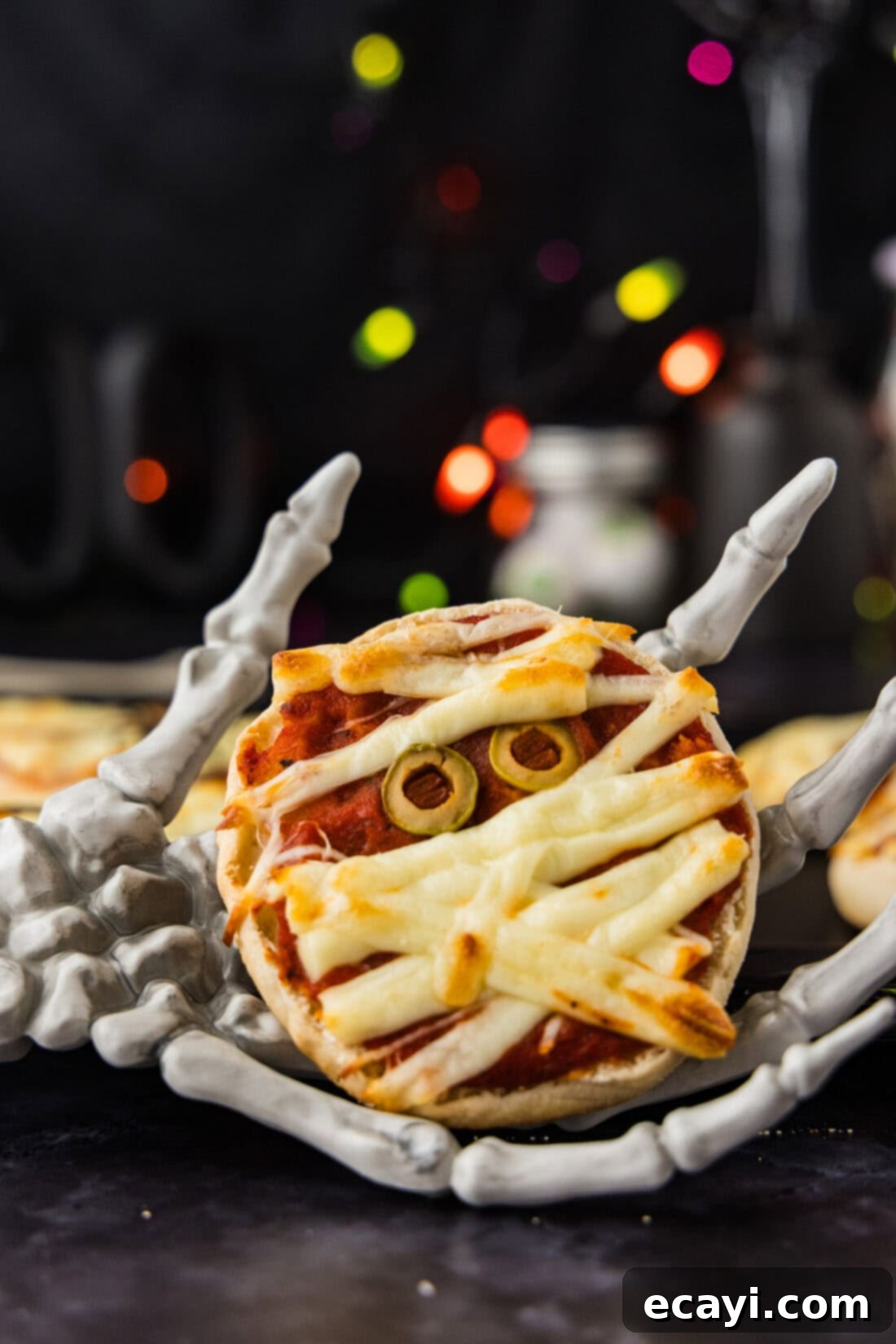 Mummy Mini Pizza Bites 2 Mini Mummy Pizza in a skeleton hand