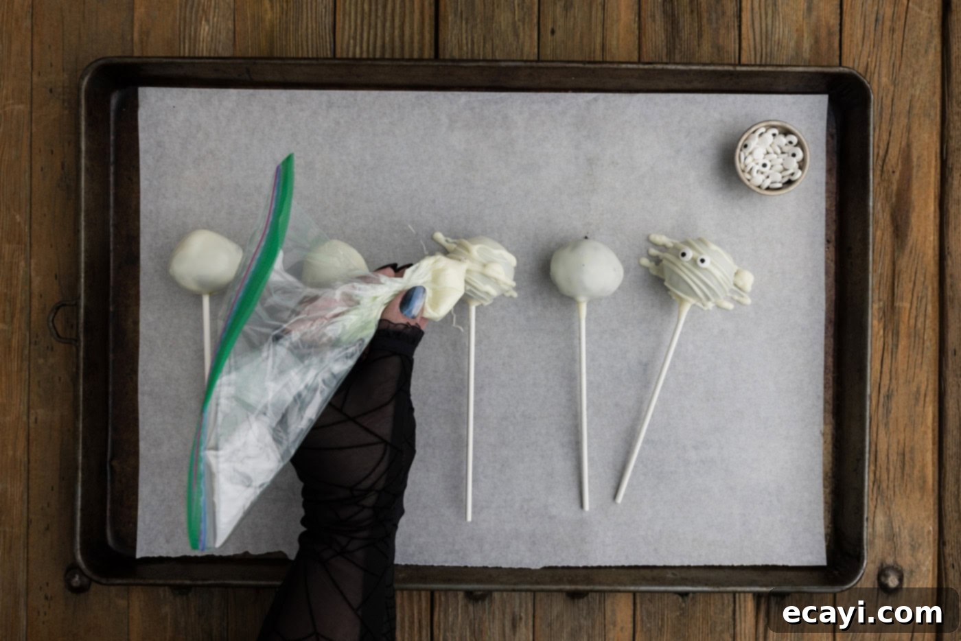 Pharaoh's Pops 12 Drizzling melted white candy wafers over the top of white chocolate coated Oreo truffles to create a mummy bandage effect, then adding candy eyes