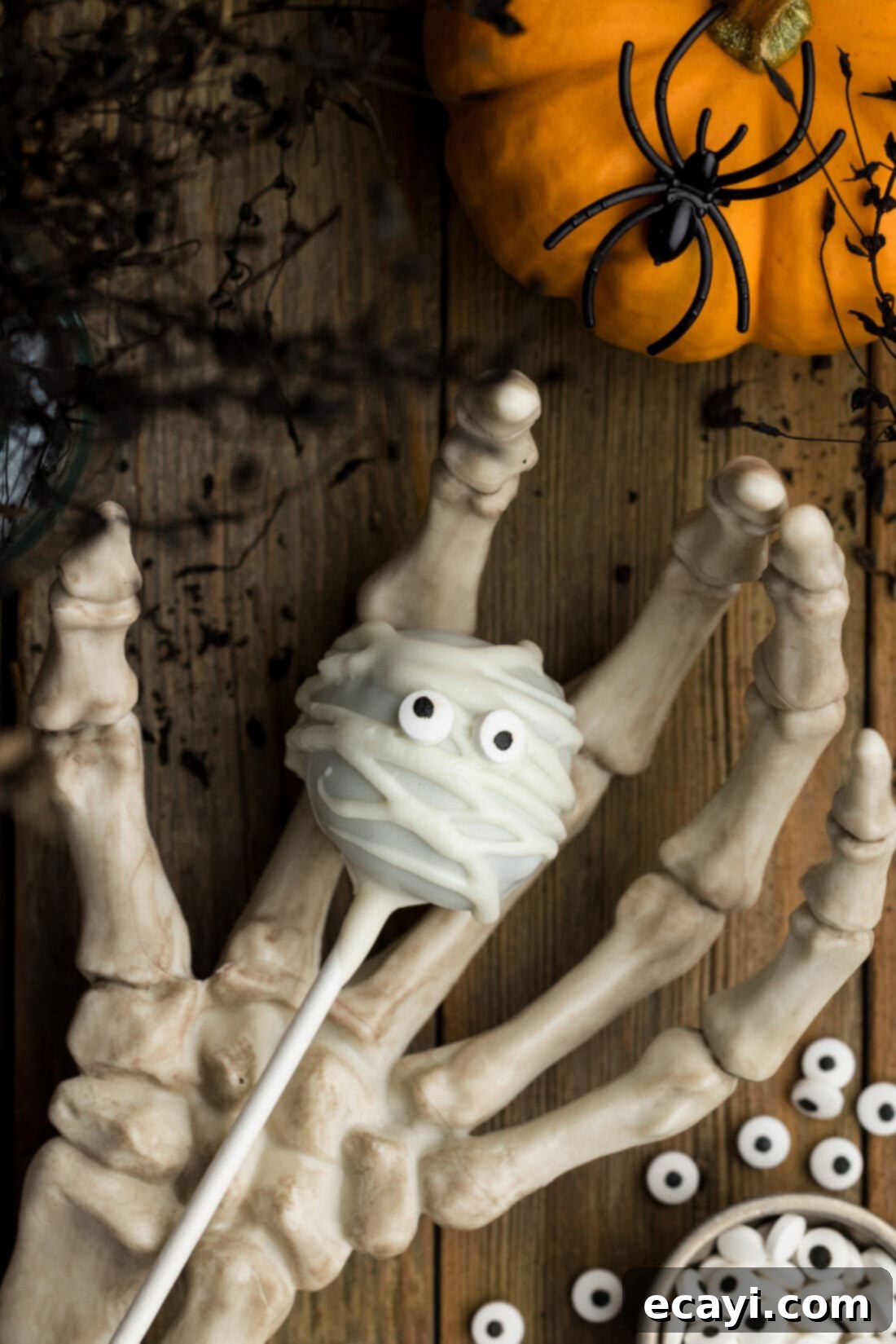 Pharaoh's Pops 13 Mummy Pop resting in a skeleton hand, perfect for a spooky display
