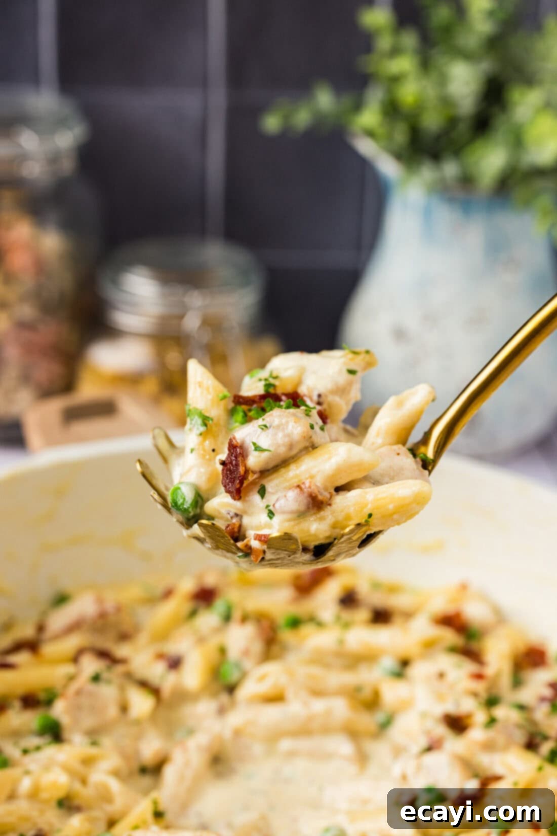 Luscious Chicken Carbonara 3 Spoonful of Chicken Carbonara held above a skillet of Chicken Carbonara