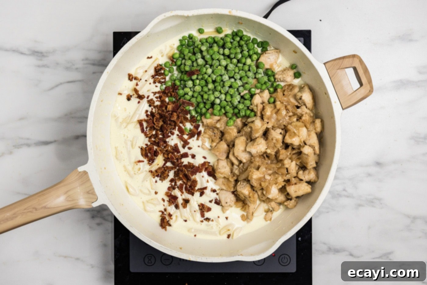 Luscious Chicken Carbonara 9 peas, crumbled bacon, and chicken added to skillet with pasta and cream sauce