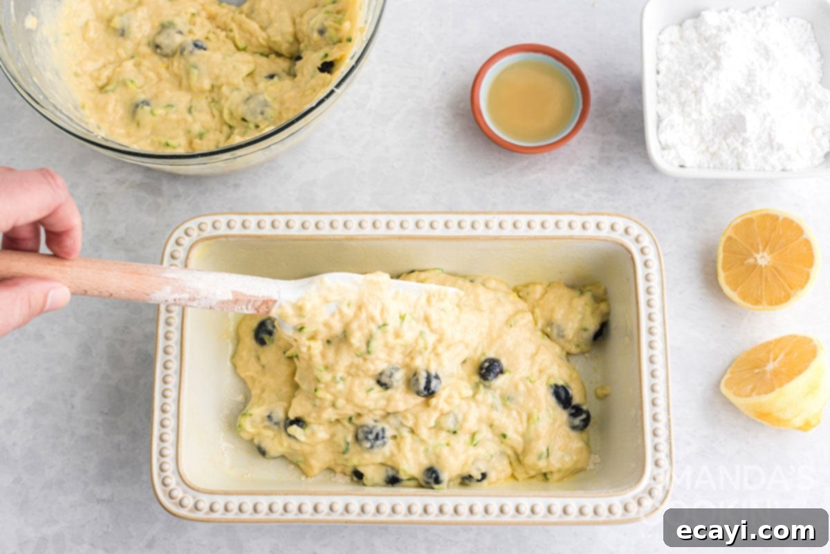 Sweet & Tangy Zucchini Berry Loaf 10 adding lemon blueberry zucchini bread batter to pan