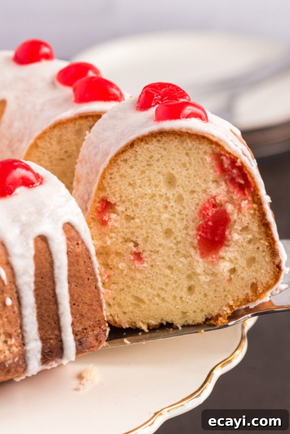 Ruby Maraschino Bundt 2 Slice of Maraschino Cherry Bundt Cake being removed from the bundt cake
