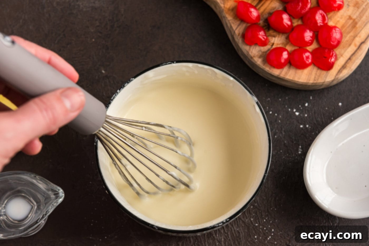 Ruby Maraschino Bundt 14 whisking almond butter glaze in a bowl