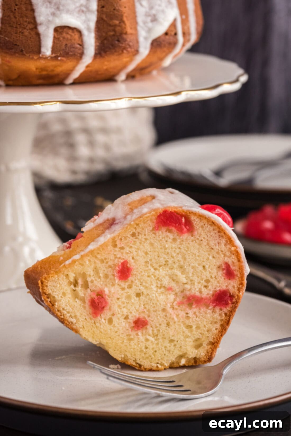 Ruby Maraschino Bundt 18 Slice of Maraschino Cherry Bundt Cake on a plate