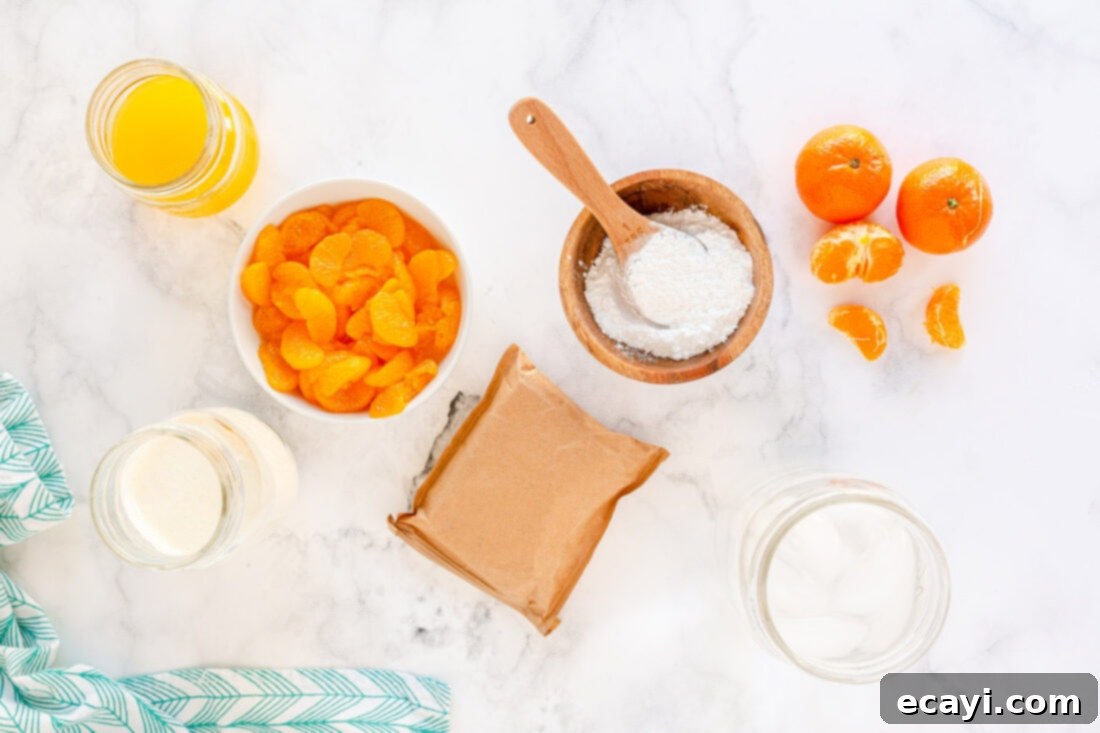 Sunshine Mandarin Whipped Mousse 4 Key ingredients for whipped jello mousse: a box of orange sugar-free Jell-O, a container of whipping cream, and a can of mandarin oranges.