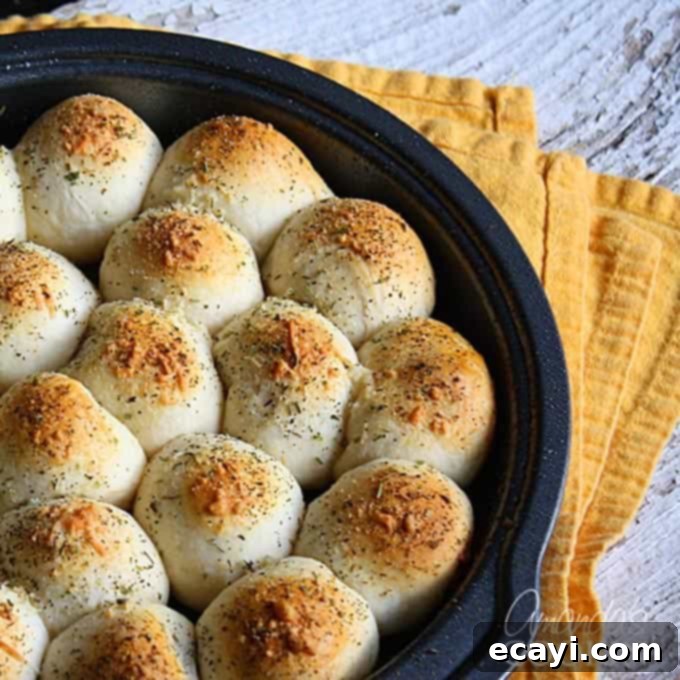 Meatball Biscuit Bombs 2 A close up photo of meatball stuffed biscuits in a cake pan.
