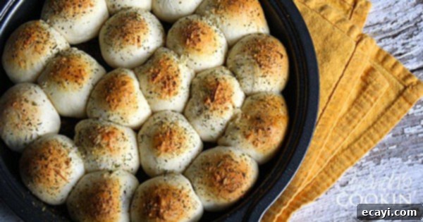 Meatball Biscuit Bombs 3 A close up photo of meatball stuffed biscuits in a cake pan.