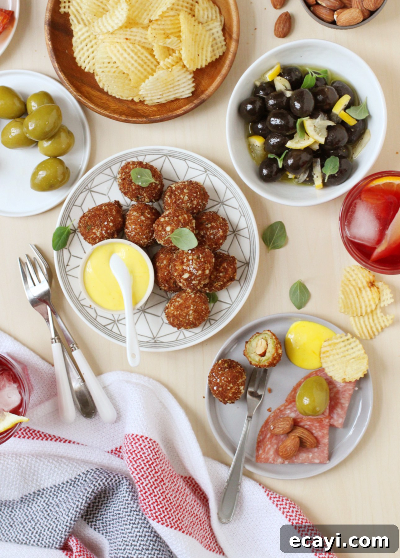 Golden Fried Olives with Saffron Aioli 3 Fried olives made with plump green olives and stuffed with almonds are a tasty snack to enjoy with cocktails // FoodNouveau.com
