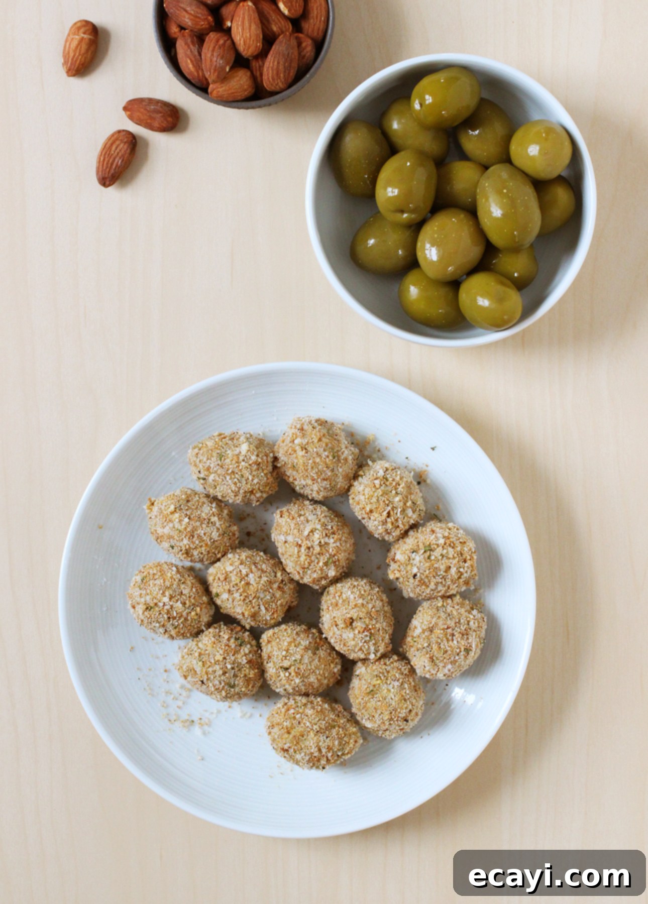 Golden Fried Olives with Saffron Aioli 4 Fried olives made with plump green olives and stuffed with almonds are a tasty snack to enjoy with cocktails // FoodNouveau.com