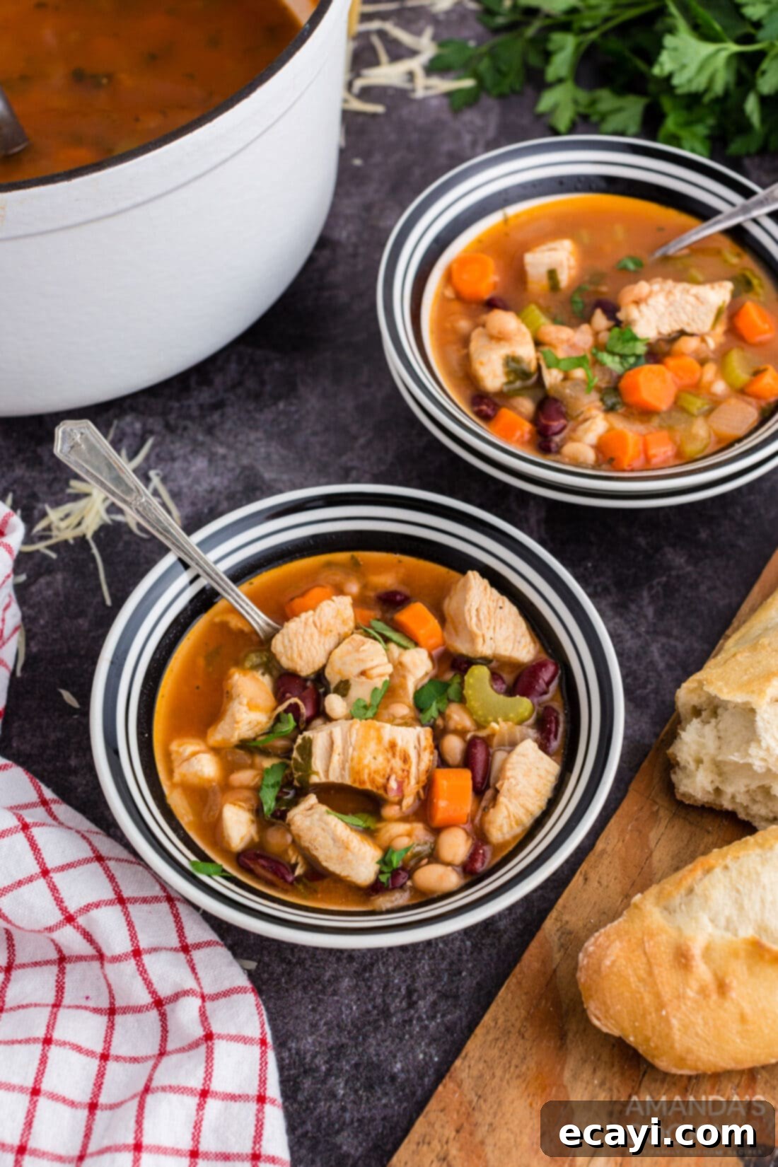 Homestyle Chicken Bean Warmth 11 Multiple bowls of hearty chicken bean soup, garnished with fresh herbs, elegantly arranged on a rustic wooden table, ready to be enjoyed.