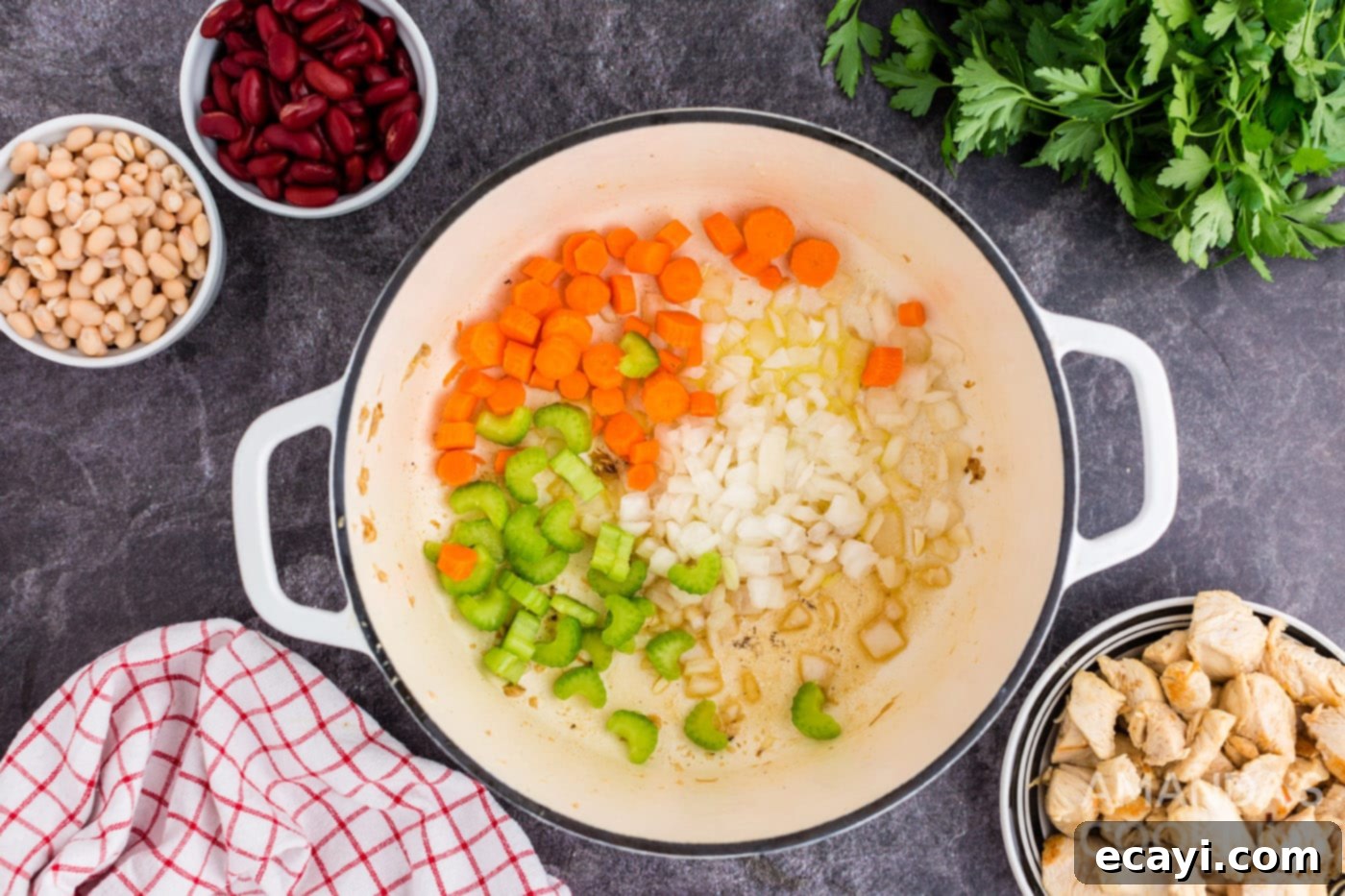 Homestyle Chicken Bean Warmth 6 Chopped onions, carrots, and celery sautéing in a Dutch oven until softened and lightly browned, releasing their aromas.
