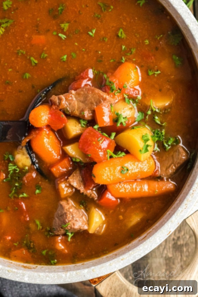Anytime is the perfect time of year to make this dutch oven goulash. This dutch oven goulash recipe is pure comfort food and so delicious! #goulash #beefdinner #beefstew #beefstewrecipe #goulashrecipe #dutchovenrecipes #dinner #beefstewcubes #potatoes #onions #carrots #paprika #comfortfood goulash stew in a pan