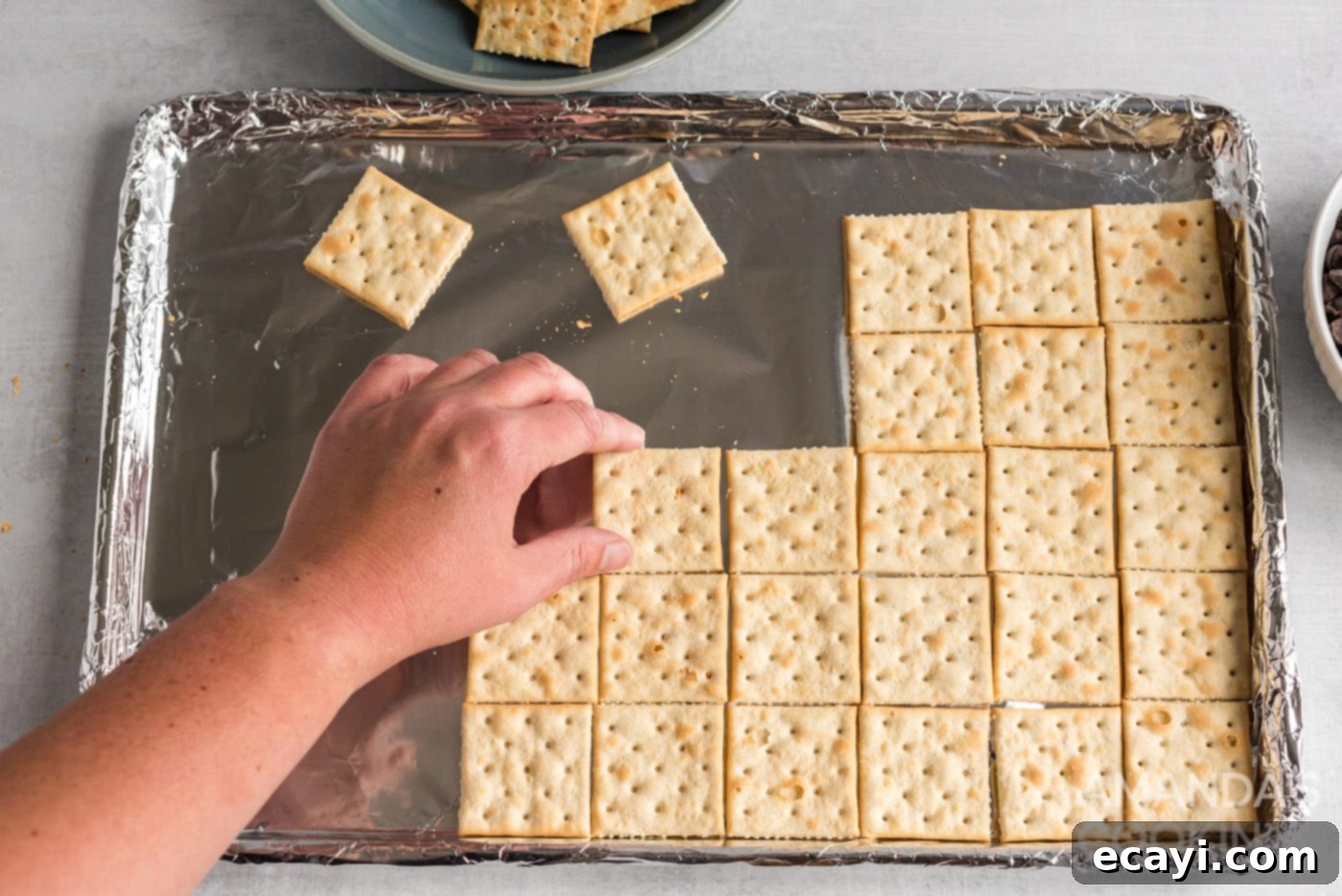 Salty Sweet Toffee Crunch 5 saltine crackers on a baking sheet