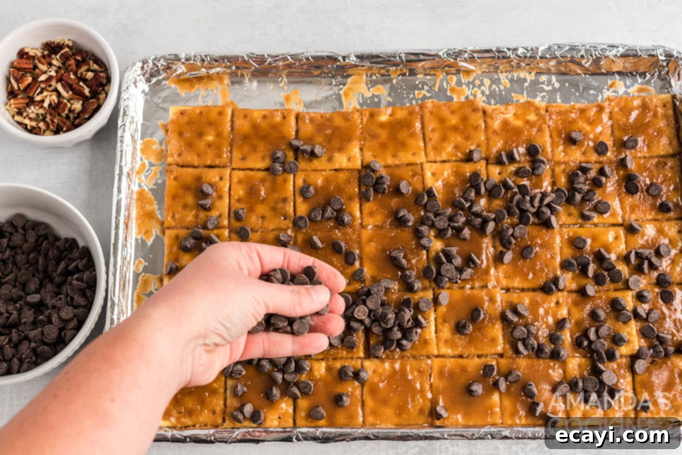 Salty Sweet Toffee Crunch 10 hand sprinkling chocolate chips onto caramel crackers