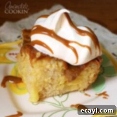 Dreamy Vanilla Slow Cooker Cake 2 A close up photo of vanilla dream crock pot cake topped with Cool Whip and drizzled Dulce de Leche.