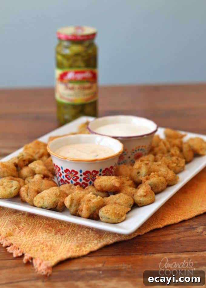 Crispy Fried Jalapeno Bites 3 A plate of crispy fried jalapeno slices served with dipping sauces.