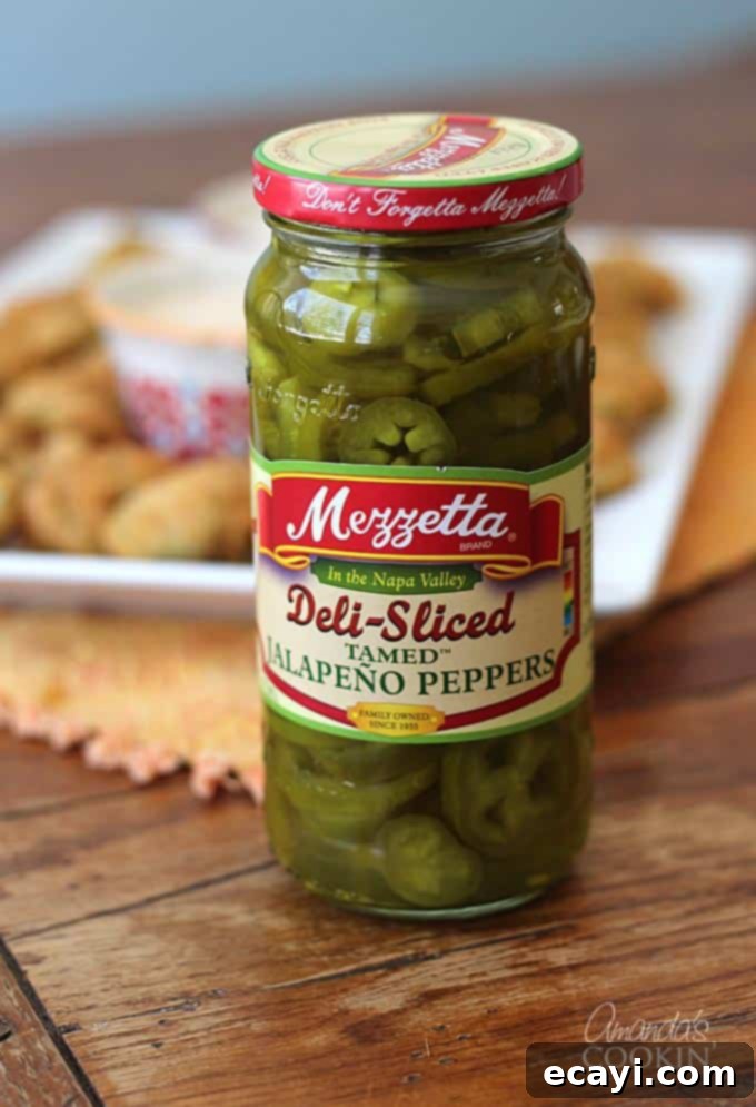 Crispy Fried Jalapeno Bites 7 A close up photo of a jar of deli sliced jalapeño peppers.