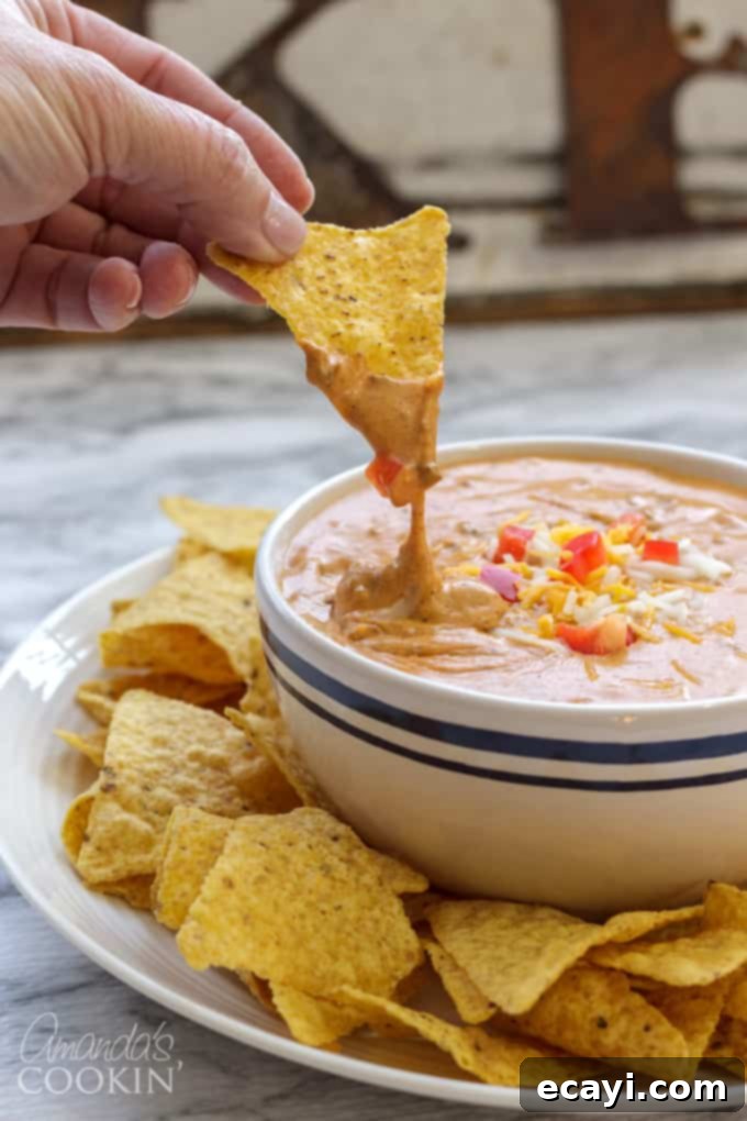 Super easy 3-ingredient microwave chili cheese dip for parties, game day, and potlucks! chili cheese dip with tortilla chips