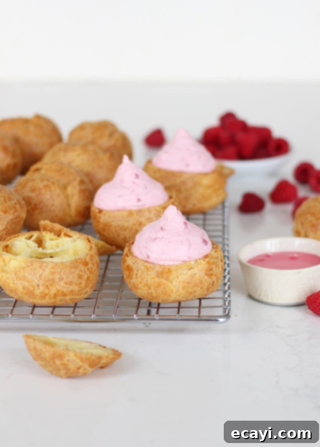 Raspberry Rose Cloud Puffs 4 A plate of freshly baked Rose Raspberry Fool Cream Puffs, ready to be filled and enjoyed.
