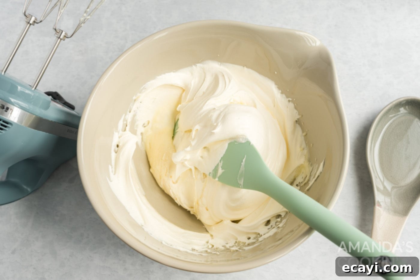 Strawberry Pretzel Delight 11 Folding thawed whipped topping into the cream cheese and sugar mixture with a spatula, creating a light and airy consistency.