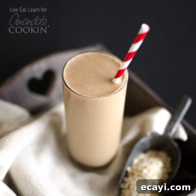 Loaded Coffee Smoothie: Your 5-Minute Energizing Breakfast. A tall glass filled with a creamy, rich brown loaded coffee smoothie, garnished with a coffee bean or a sprinkle of cocoa, suggesting a delicious and invigorating start to the day. The smoothie is shown on a light background, highlighting its smooth texture.