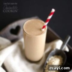 Powerhouse Coffee Breakfast Smoothie 2 A close up photo of a loaded coffee smoothie served with a red and white straw, showing its inviting texture and readiness to be enjoyed.