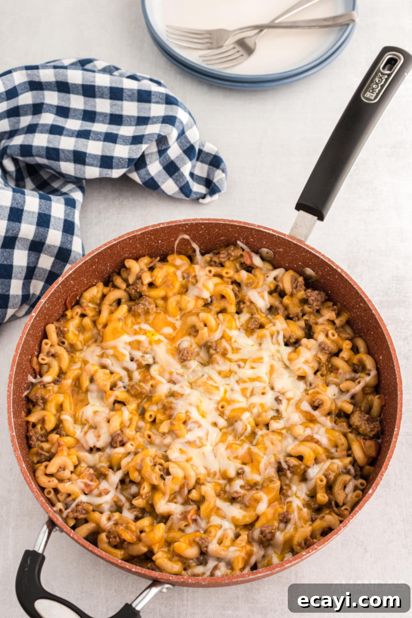 Ultimate Bacon Cheeseburger Bake 10 A completed bacon cheeseburger casserole in a skillet, topped with perfectly melted, golden-brown cheese and ready to serve.