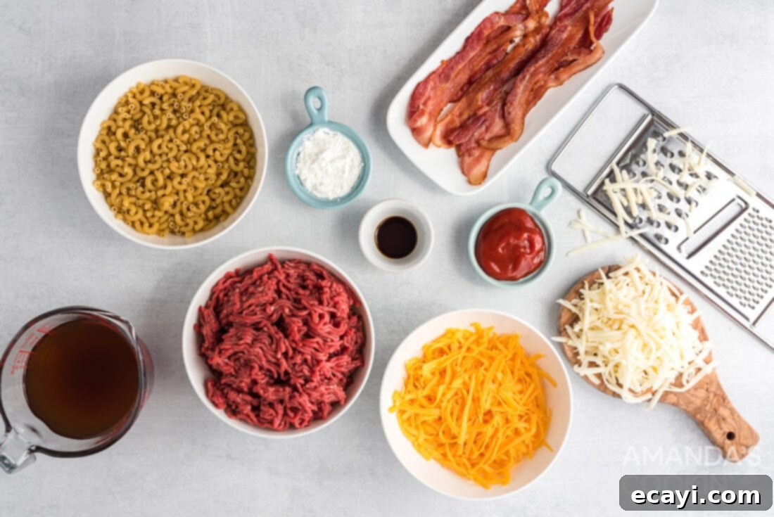 Ultimate Bacon Cheeseburger Bake 4 Various ingredients for bacon cheeseburger casserole laid out on a kitchen counter: ground beef, macaroni, cheese, bacon, ketchup, beef broth, and Worcestershire sauce.