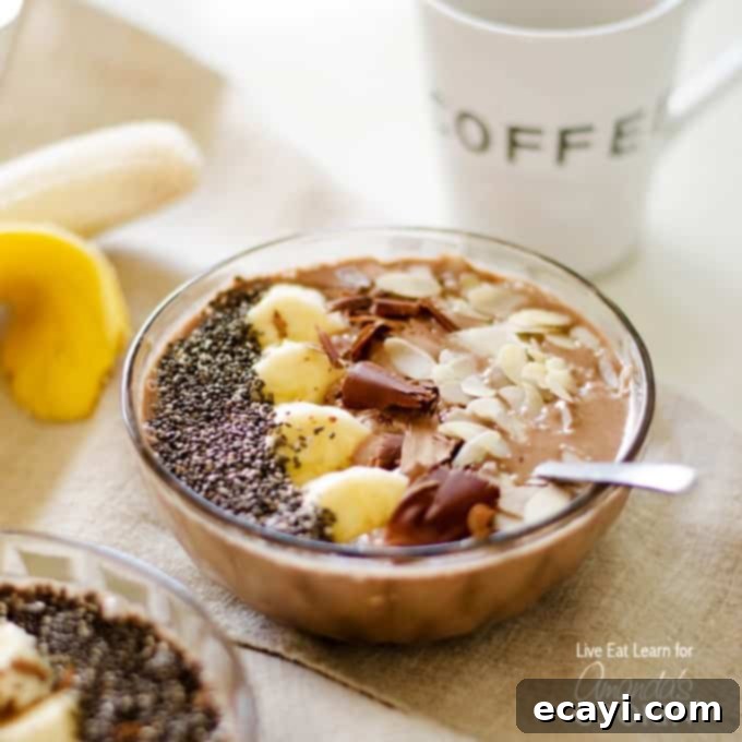 Dreamy Mocha Smoothie Bowl 2 A beautifully presented mocha smoothie bowl with a spoon, ready to be enjoyed.