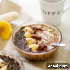 Dreamy Mocha Smoothie Bowl 6 A close up of a mocha smoothie bowl topped with sliced banana, shaved chocolate and sliced almonds.