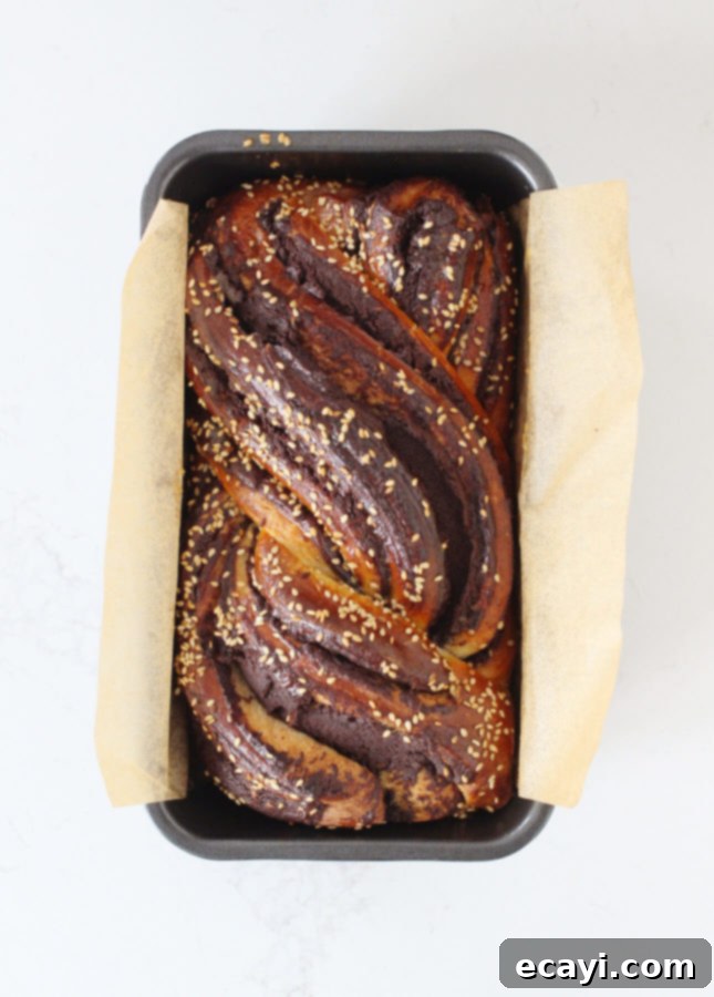 Decadent Tahini Chocolate Babka from Scratch 5 Close-up of a slice of Tahini & Chocolate Babka, showing the intricate swirls of filling.