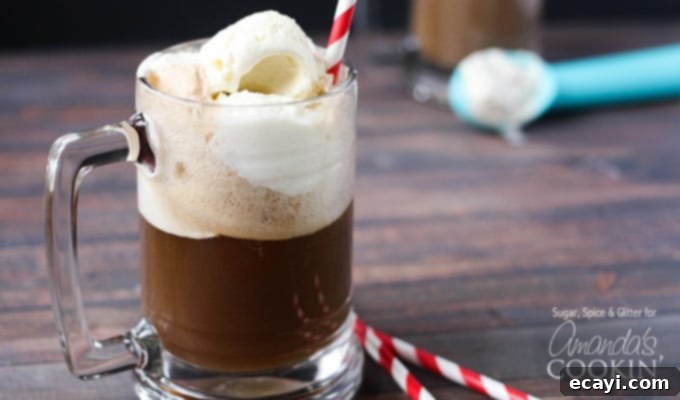 Spiked Root Beer Float 4 A photo of a root beer float cocktail in a clear mug served with a red and white striped straw.