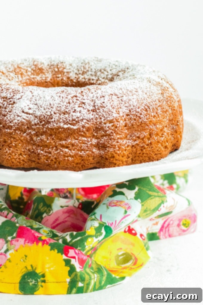 This pistachio cake is truly tender, delicious, and easy to make! Adding pistachio pudding to cake mix transforms something average into something amazing. PISTACHIO BUNDT CAKE ON CAKE PLATE