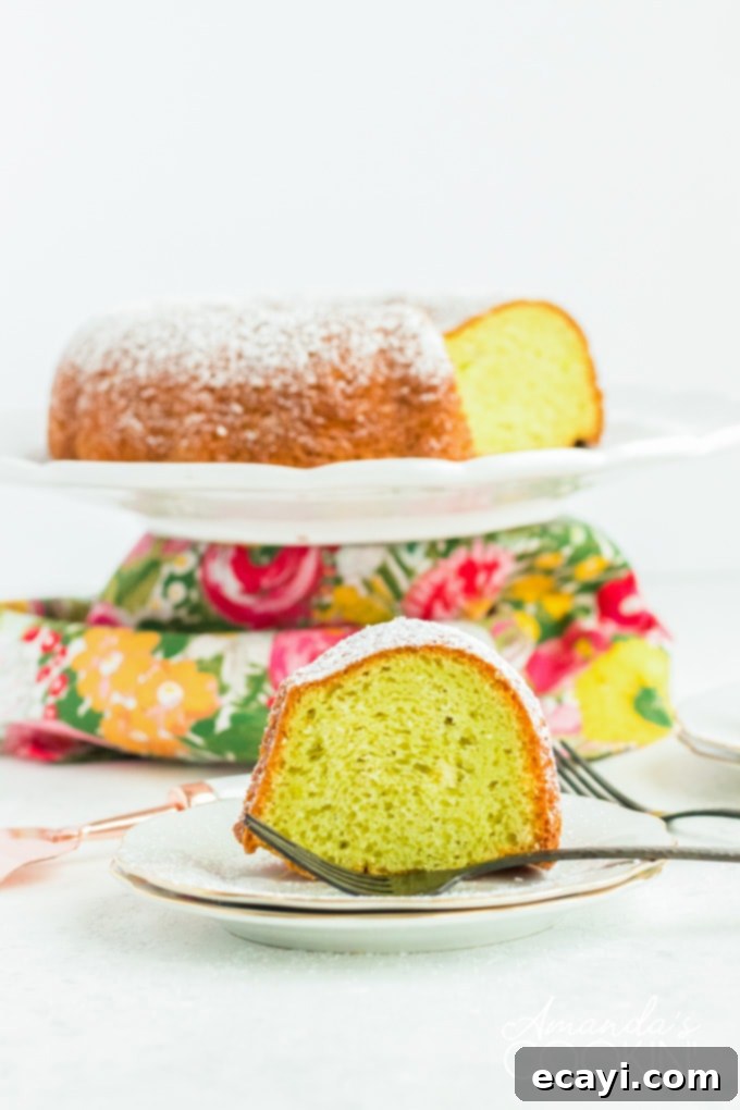 This pistachio pudding bundt cake is truly tender and delicious! Adding pistachio pudding to cake mix transforms something average into something amazing. slice of pistachio cake on plate