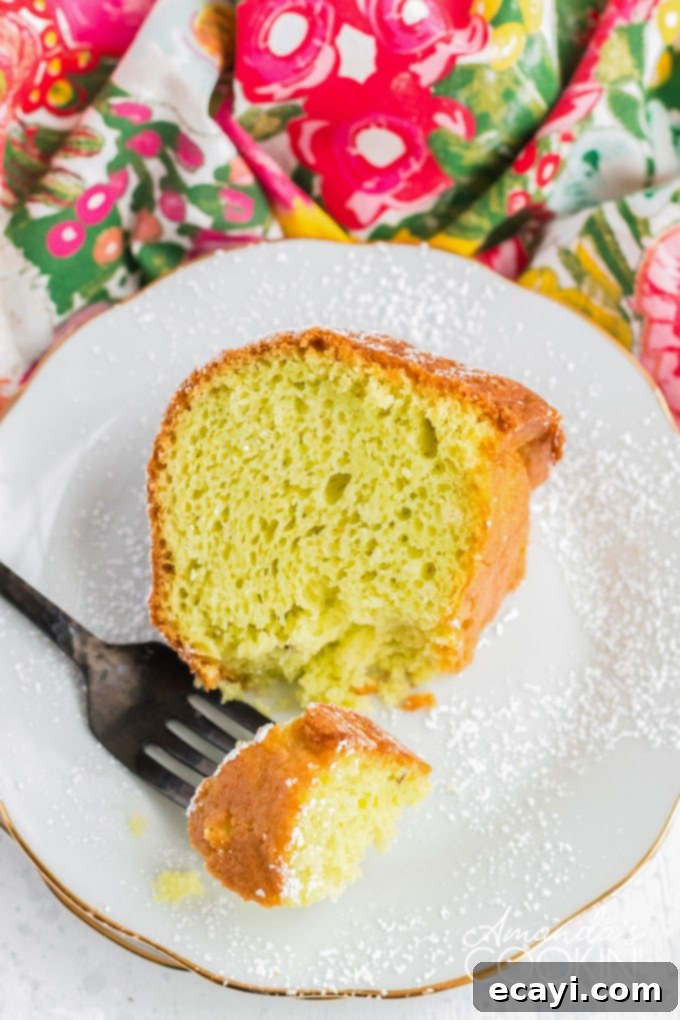 This pistachio cake is truly tender, delicious, and easy to make! Adding pistachio pudding to cake mix transforms something average into something amazing. slice of pistachio cake