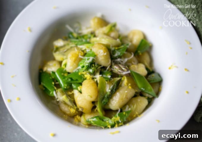 Golden Pan-Seared Gnocchi with Asparagus Ribbons and Sweet Snap Peas 4 A close up overhead photo of pan seared gnocchi with shaved asparagus and snap peas in a white bowl.