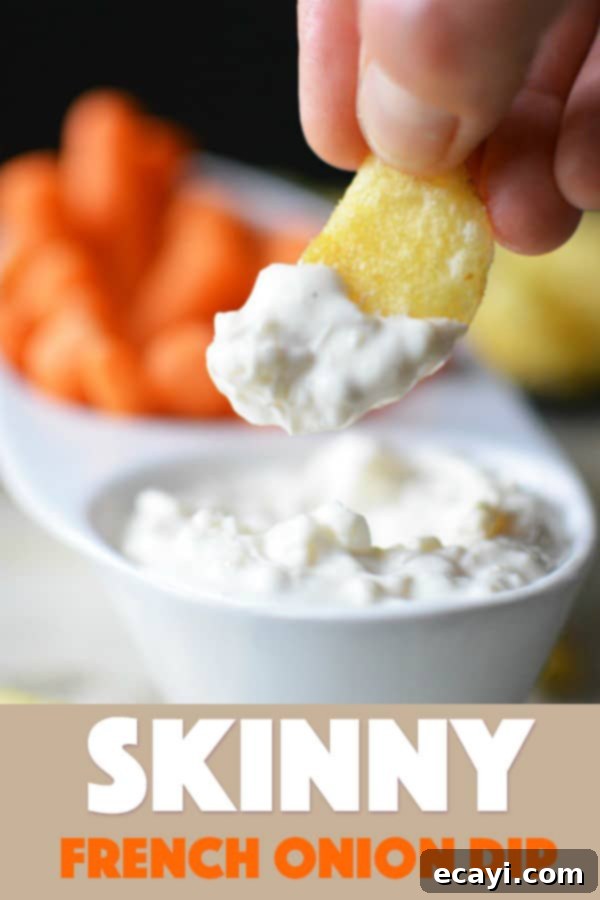 Guilt-Free French Onion Dip 9 A close up photo of a potato chip dipped in skinny French onion dip.