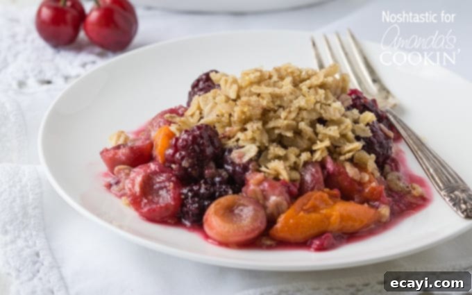 Golden Summer Fruit Crumble 4 A close up of summer fruit crisp on a white plate.