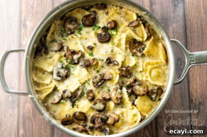 This creamy mushroom ravioli dish starts on the stove and finishes in the oven making it the perfect weeknight dinner. A stovetop casserole! creamy mushroom ravioli in pan, ready to be served