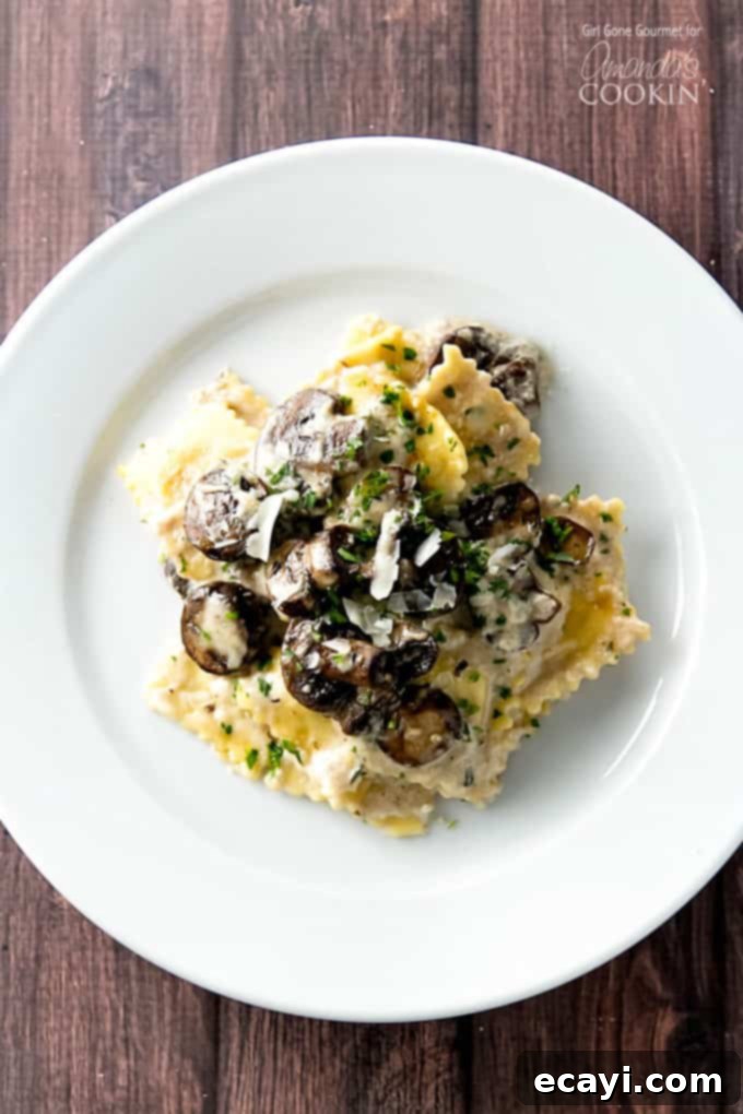 This creamy mushroom ravioli dish starts on the stove and finishes in the oven making it the perfect weeknight dinner. A stovetop casserole! Ravioli on plate topped with mushrooms and fresh herbs