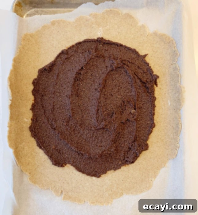 Rustic Pear & Chocolate Almond Galette 4 Arranging fanned pear slices over the chocolate frangipane layer on the galette pastry. // FoodNouveau.com
