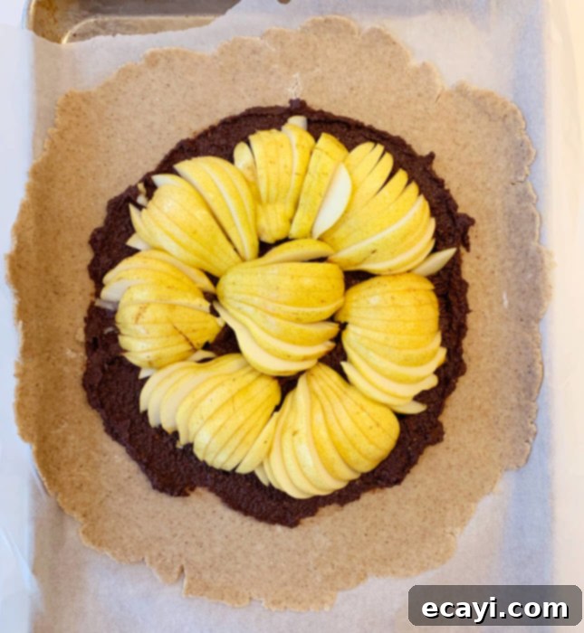 Rustic Pear & Chocolate Almond Galette 5 Gently folding the edges of the shortcrust pastry over the pear and frangipane filling. // FoodNouveau.com